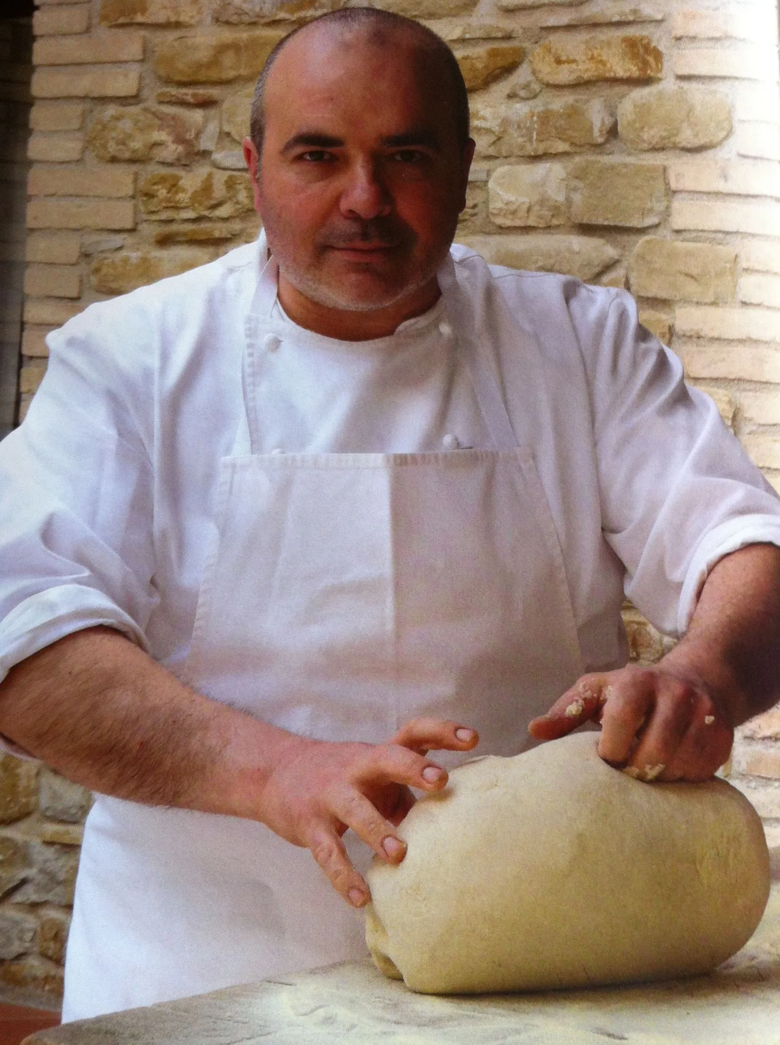 Chef Roberto Crescini shaping fresh pasta dough