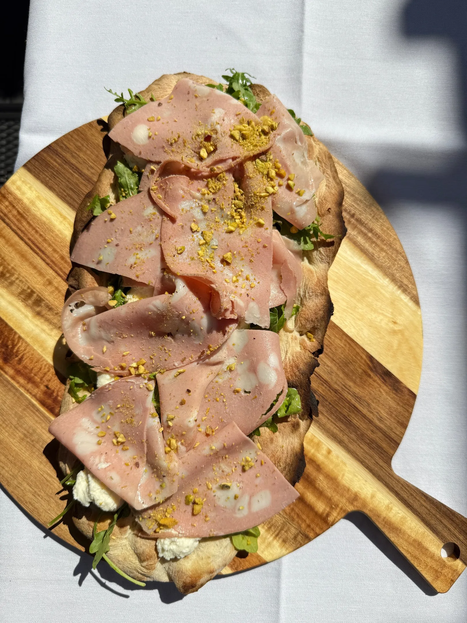 Pinsa with mortadella and pistachio